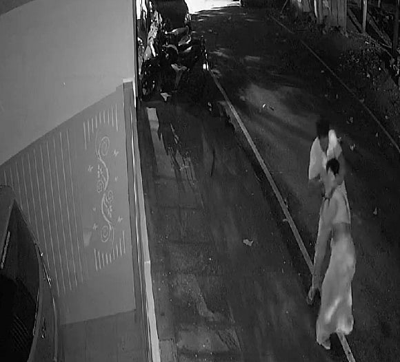X/@MithilaWaala
 : The CCTV footage of the incident shows the woman standing outside a house when a man approaches her from behind, chases and gropes her on the street.

